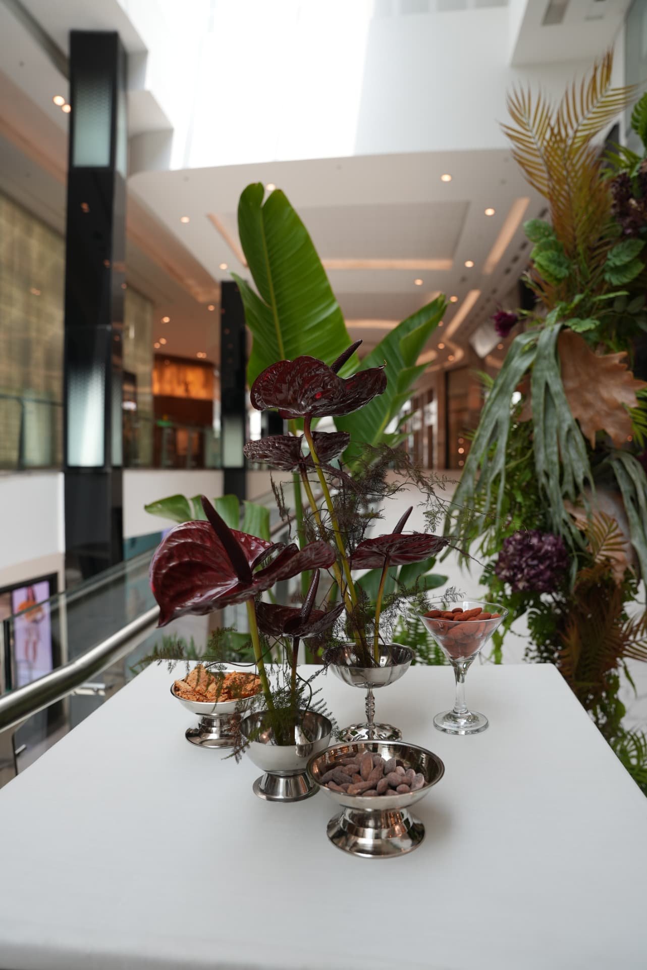 Kara.S boutique opening at Morocco Mall — burgundy anthurium and pink cymbidium installations, silver coupes and brass tables, produced by SBAI Events Production