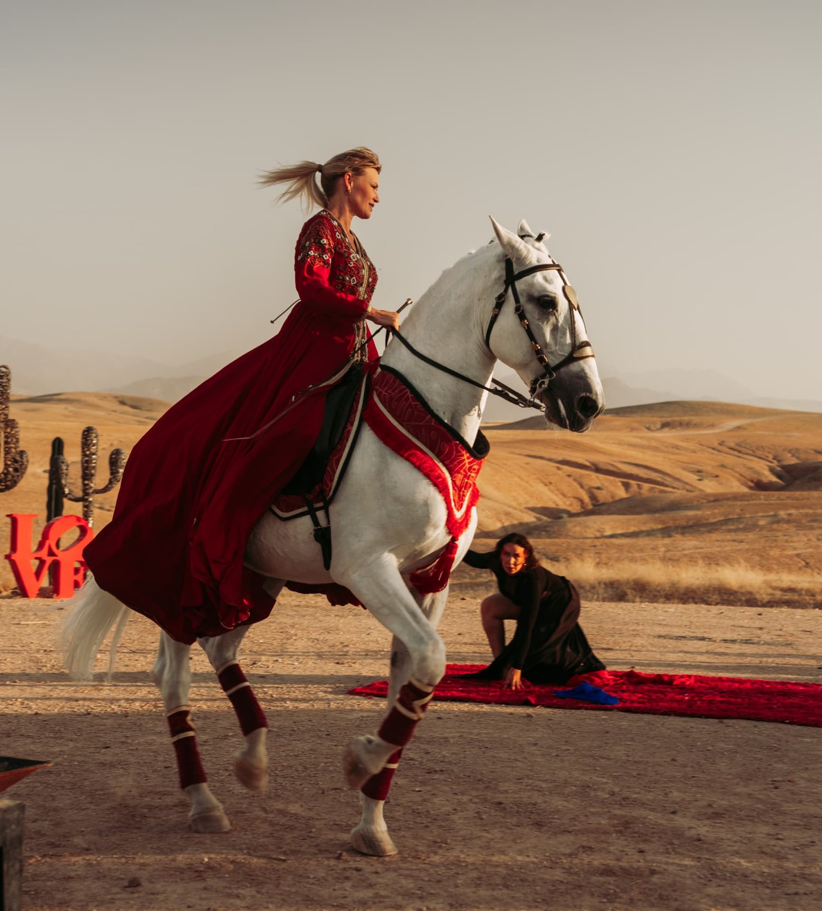Celebration in the Agafay desert near Marrakech — equestrian performance in red, desert lounges, pampas tablescapes and fireworks, produced by SBAI Events Production