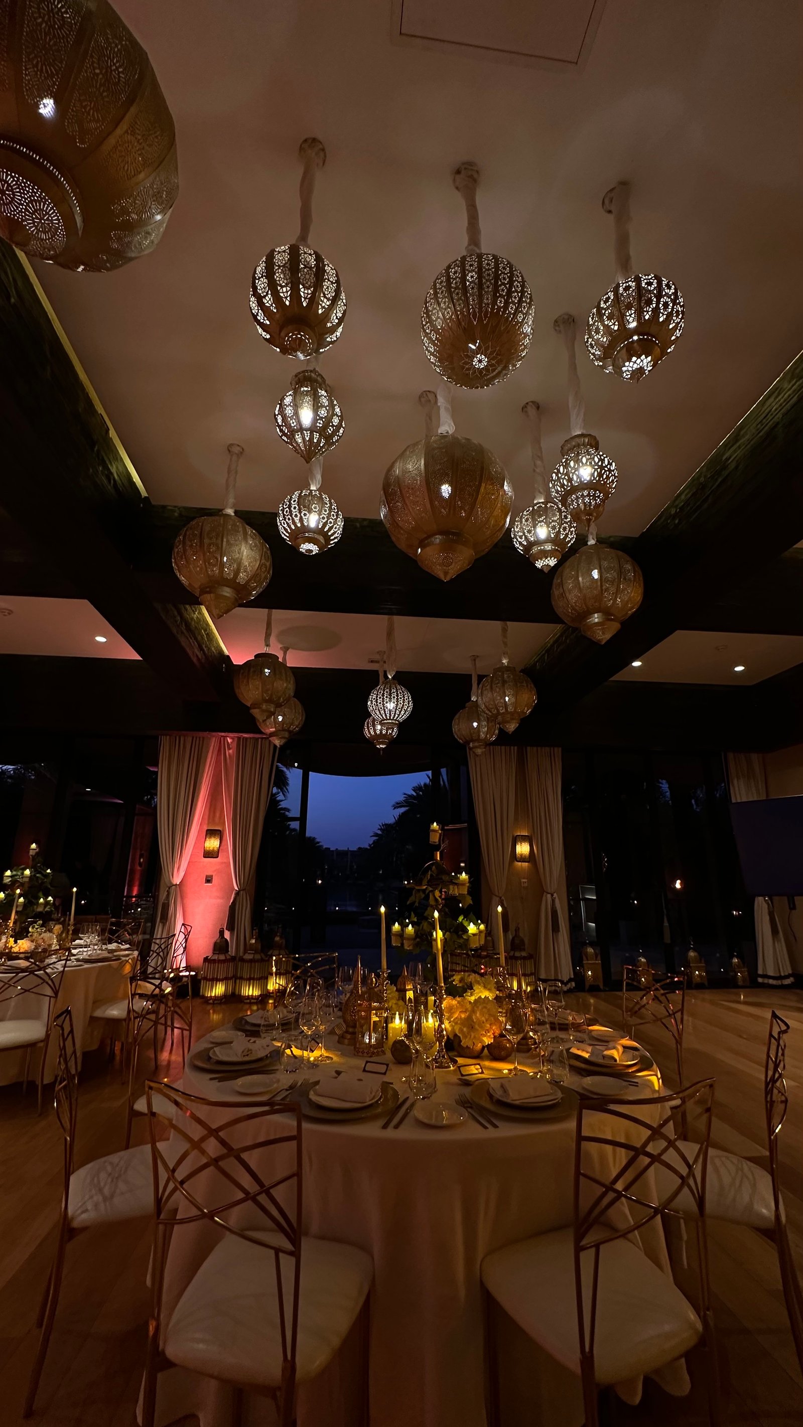 One Thousand and One Nights soirée at the Mandarin Oriental Marrakech — clouds of pierced brass lanterns, candlelit tablescapes and gold accents, produced by SBAI Events Production