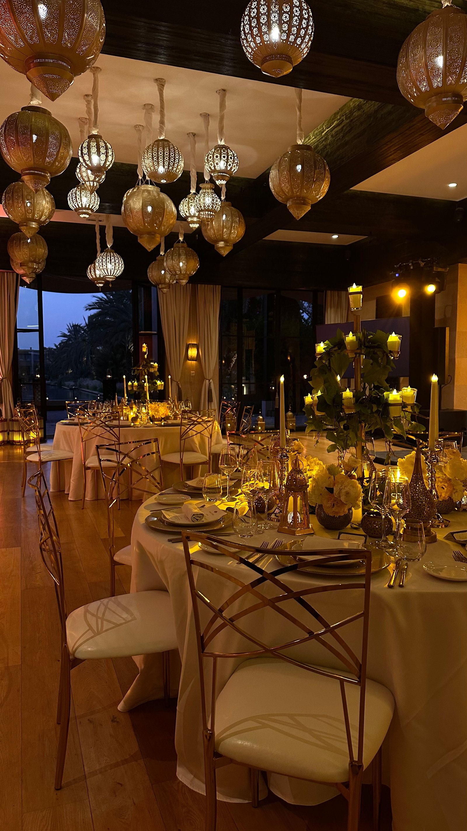 One Thousand and One Nights soirée at the Mandarin Oriental Marrakech — clouds of pierced brass lanterns, candlelit tablescapes and gold accents, produced by SBAI Events Production