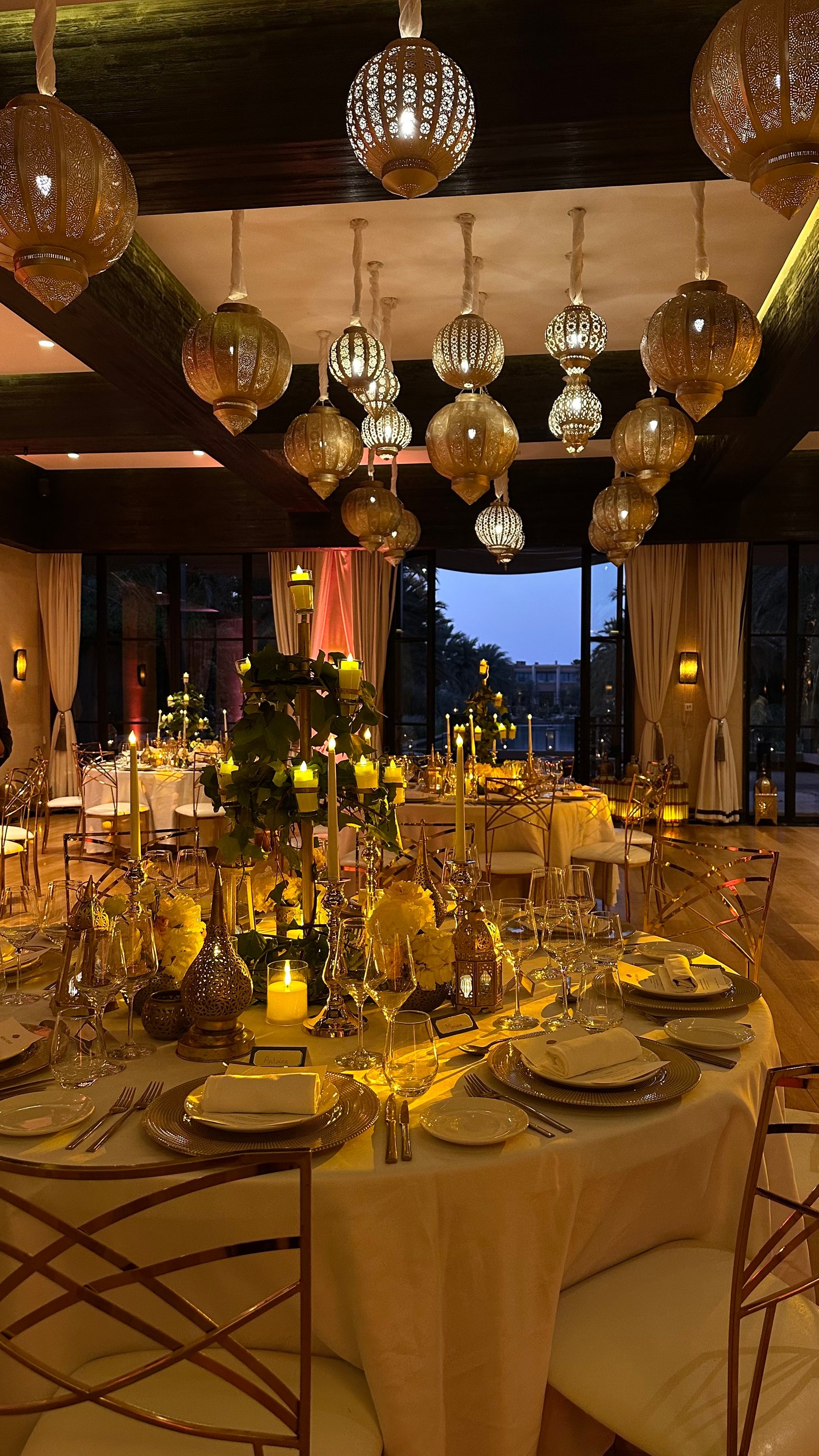 One Thousand and One Nights soirée at the Mandarin Oriental Marrakech — clouds of pierced brass lanterns, candlelit tablescapes and gold accents, produced by SBAI Events Production