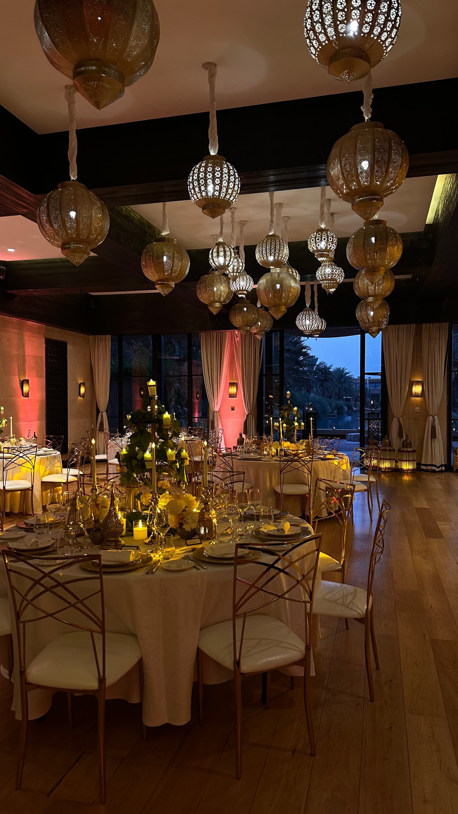 One Thousand and One Nights soirée at the Mandarin Oriental Marrakech — clouds of pierced brass lanterns, candlelit tablescapes and gold accents, produced by SBAI Events Production