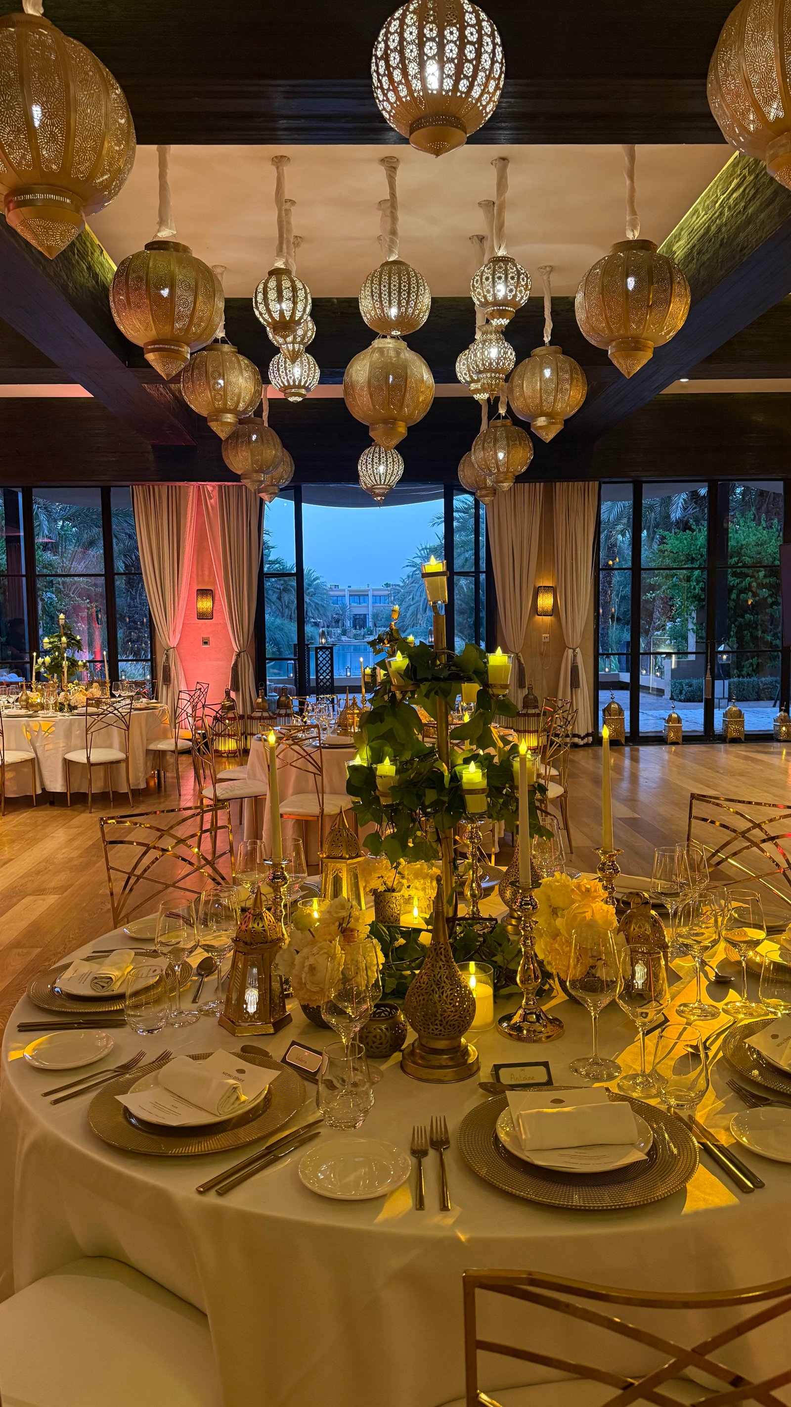 One Thousand and One Nights soirée at the Mandarin Oriental Marrakech — clouds of pierced brass lanterns, candlelit tablescapes and gold accents, produced by SBAI Events Production